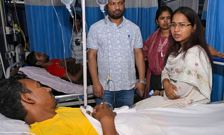Jharkhand Agriculture Minister Shilpi Neha Tirkey interacts with a protester who was admitted to a hospital after falling ill during an indefinite hunger strike, in Ranchi, Wednesday, Aug. 12, 2026