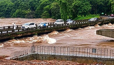 Vehicles move across a bridge as the swollen Netravathi river flows in spite of heavy rainfall, at Nidle Kudraya, in Dakshina Kannada district, Karnataka, Saturday, Aug. 1, 2026. (PTI Photo)