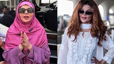 Rakhi Sawant in a pink hijab and sunglasses, praying with hands folded at an outdoor event.