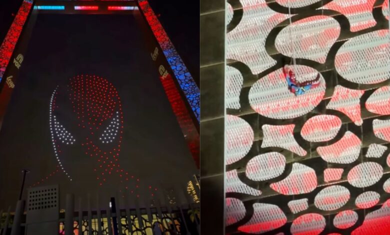 Spider-Man descends Dubai Frame as drones form his mask in the sky.