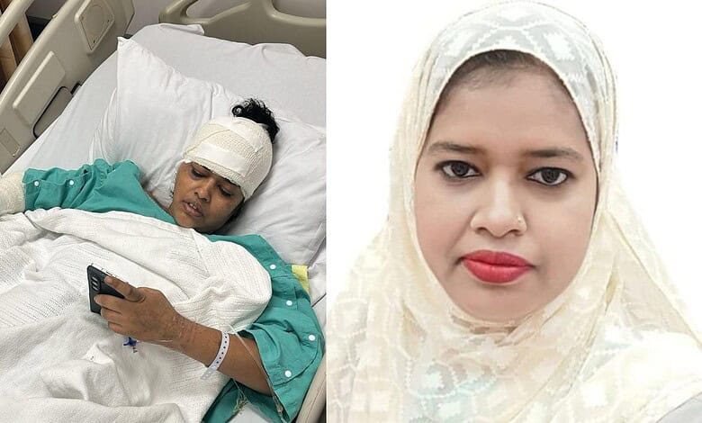 Injured woman with head bandage lying in hospital bed holding a mobile phone.