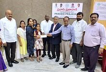 Group of people presenting aid to a young girl in a community event in Telangana.