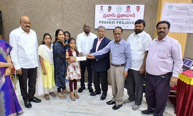Group of people presenting aid to a young girl in a community event in Telangana.
