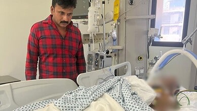 Indian man in hospital with medical equipment after accident in Saudi Arabia.