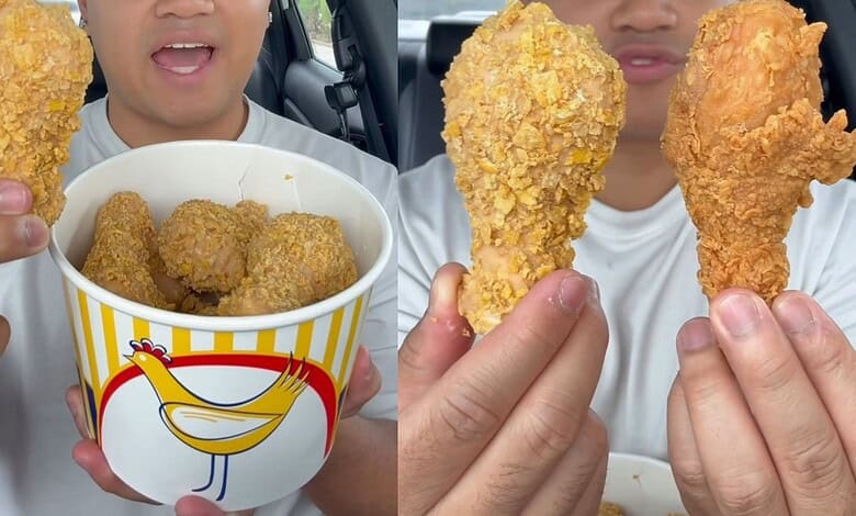 Person holding fried chicken drumsticks and a bucket of fried chicken, close-up view.