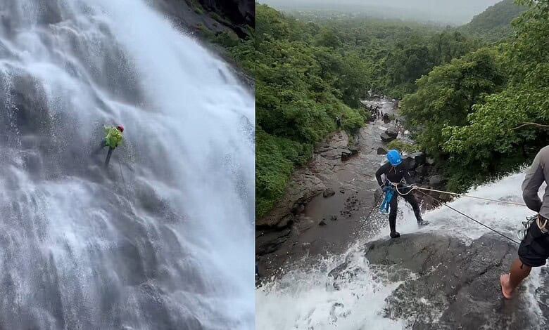 Two climbers exploring a waterfall and river in lush green forest landscape.