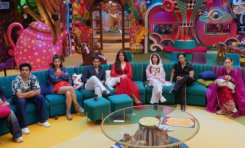 Bigg Boss 20 contestants sitting on colourful sofas in the house.