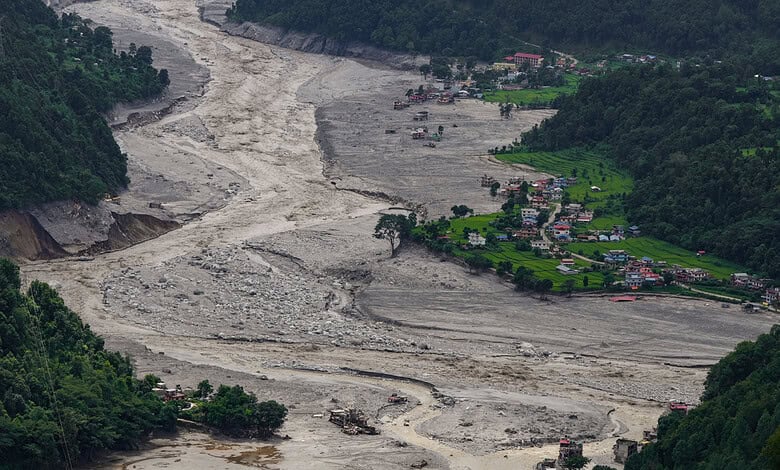 A view of damaged and half-buried buildings under silt and debris following devastating flash floods, at Betrawati market, in Nuwakot district, Nepal, Wednesday, Sept. 2, 2026.