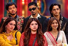 Group of Bigg Boss contestants posing together in colourful outfits.