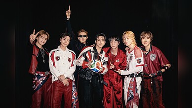 Korean band BTS in Hyderabad, seven members in stylish outfits on stage.
