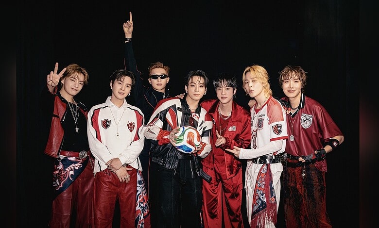 Korean band BTS in Hyderabad, seven members in stylish outfits on stage.