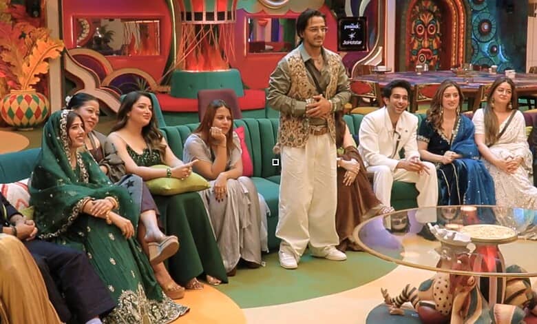 Bigg Boss 20 week 1 contestants seated in colourful set, engaging in discussion.