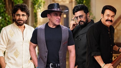 Four men standing outdoors, dressed in casual and traditional attire, with trees in the background.
