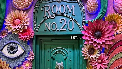 Decorative door of Bigg Boss 20 house with colourful paper flowers and eye motif.