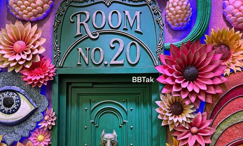 Decorative door of Bigg Boss 20 house with colourful paper flowers and eye motif.