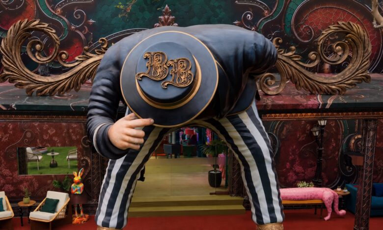Person in Bigg Boss 20 house wearing a hat and striped pants, bowing down.