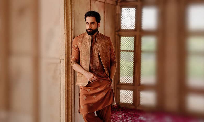 Bilal Abbas Khan wearing traditional attire, standing indoors with a wooden window in the background.