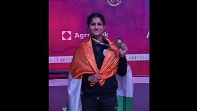 Suchika Tariyal with her medal at the Asian Games, draped in the Indian flag.