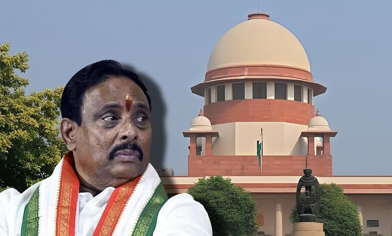 Indian politician in traditional attire outside the Supreme Court of India building.