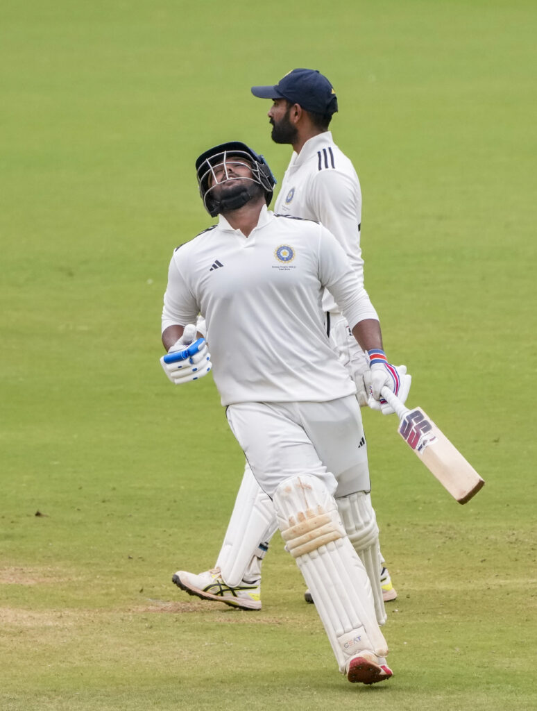 Indian cricket players celebrating on the field during a match at the Duleep Trophy.