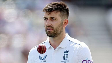 England cricketer Mark Wood in white uniform during a match.