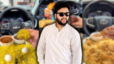 Young man with sunglasses in a car, smiling, with food and drinks in the background.