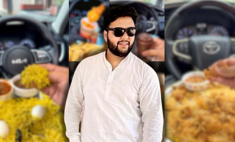 Young man with sunglasses in a car, smiling, with food and drinks in the background.