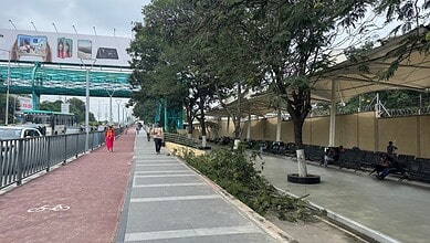 Hyderabad's well-maintained footpath in Hitech City with trees and seating areas.