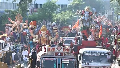 Ganesh idols and festive floats during immersion procession in Hyderabad.