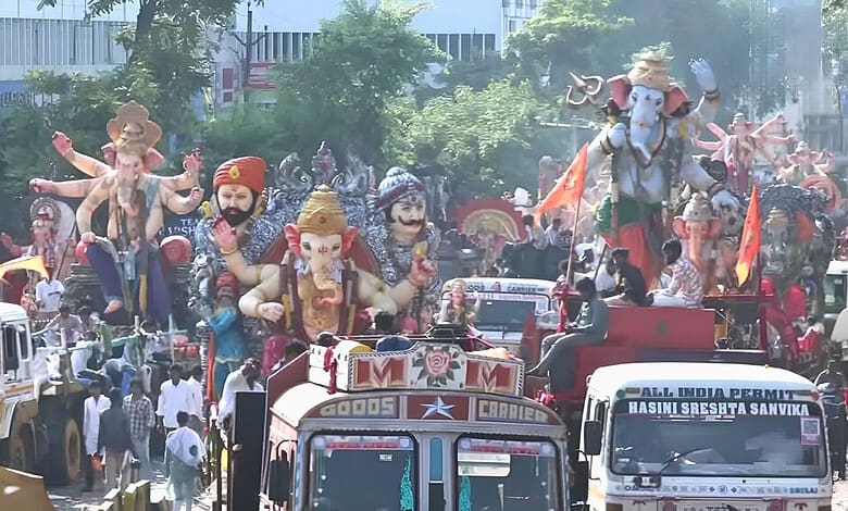 Ganesh idols and festive floats during immersion procession in Hyderabad.