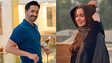 Hania Aamir and Danish Taimoor smiling outdoors, casual attire, natural background.