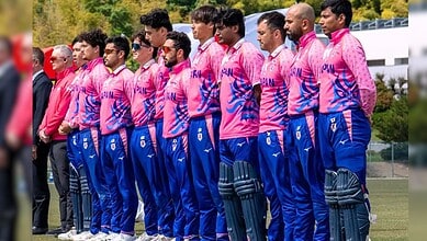 Japanese cricket team in pink and blue uniforms during a match or practice session.