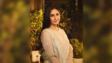 Katrina Kaif with long dark hair and elegant attire at an outdoor event.