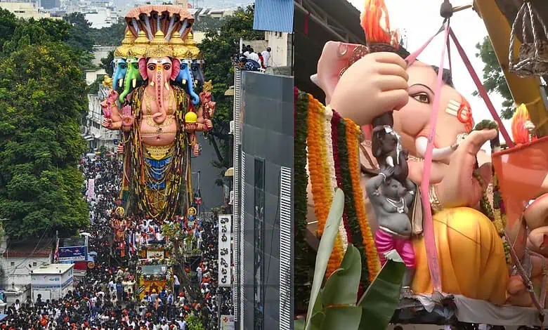 Large Ganesh idol being carried for immersion during Ganesh Chaturthi celebrations.