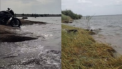 Serene lake near Hyderabad with grassy shoreline and calm waters, perfect for a peaceful escape.