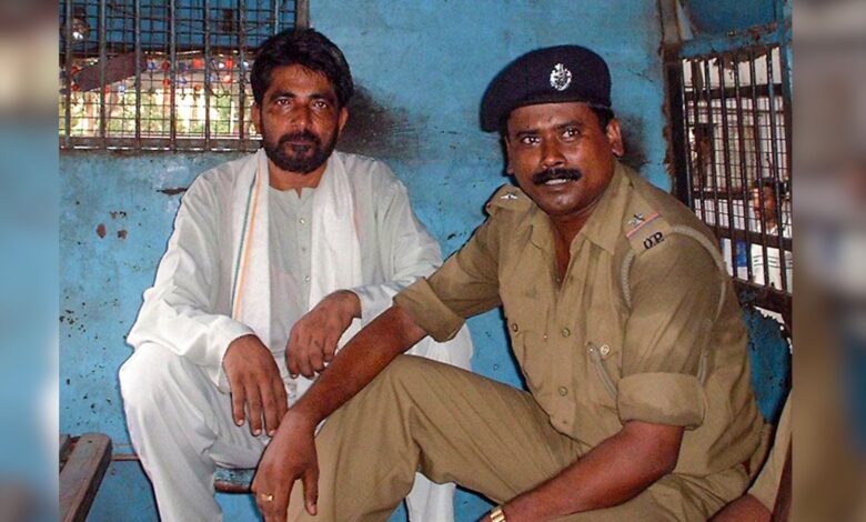 The Odisha government has rejected a plea of Hindutva activist Dara Singh for premature release from prison in the murder of Australian missionary Graham Staines and his two minor sons in Keonjhar in 1999, Singh is seen along with a police official in a former image, Tuesday, Sept. 15, 2026. (PTI Photo)