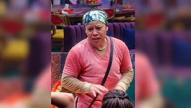 Mary Kom in a pink top and headscarf, speaking passionately in a room with purple furniture.