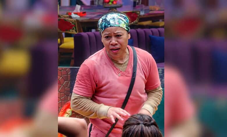 Mary Kom in a pink top and headscarf, speaking passionately in a room with purple furniture.