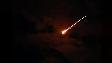 Missile streaking across the night sky.