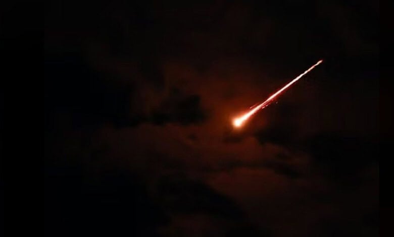 Missile streaking across the night sky.