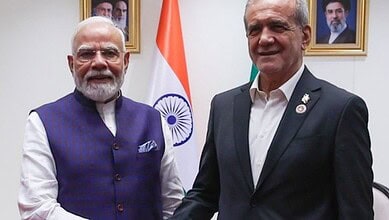 Indian Prime Minister Narendra Modi and Iranian Deputy Speaker of Parliament Ali Pezeshkian shake hands.