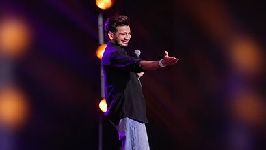 Comedian Munawar Faruqui performing on stage during a fan event in Dubai.
