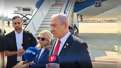 Israeli Prime Minister Benjamin Netanyahu speaks to the media upon arrival at the airport.