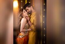 Nikki Tamboli and Arbaaz Patel celebrating Haldi with joyful smiles and traditional attire.