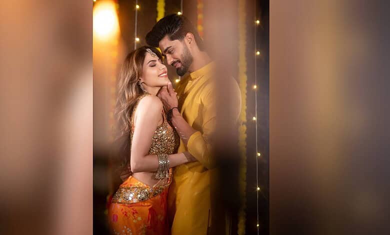 Nikki Tamboli and Arbaaz Patel celebrating Haldi with joyful smiles and traditional attire.