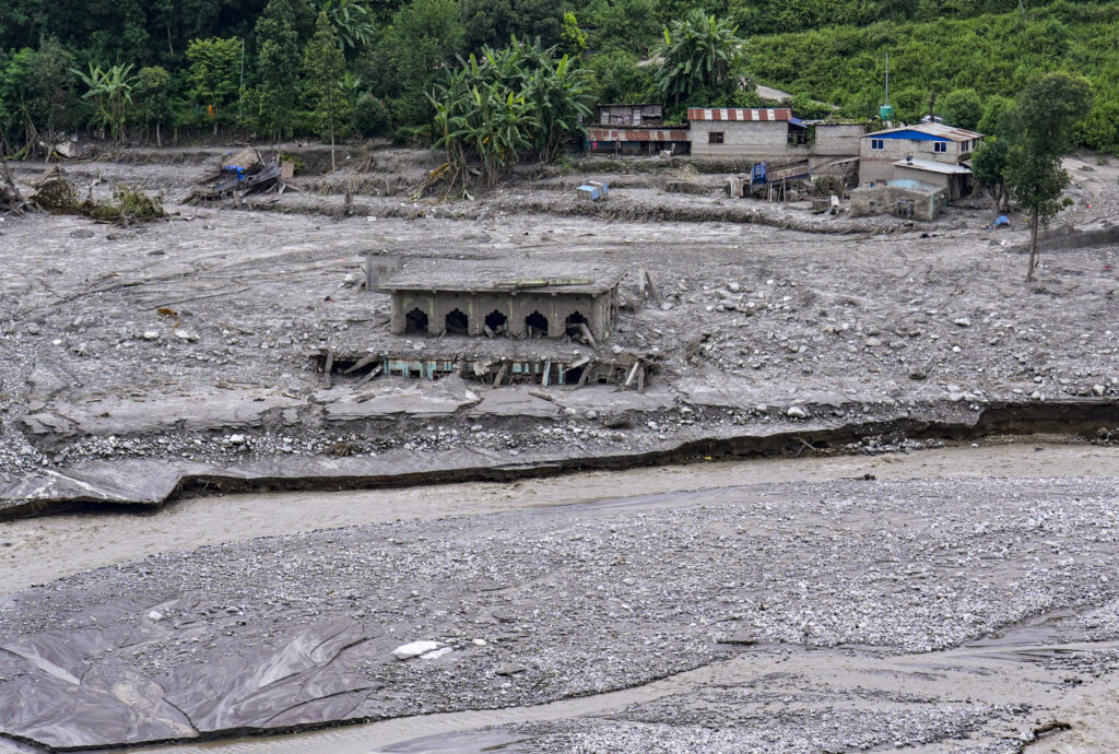 Damaged road and infrastructure in Nepal amid efforts to restore vital links with India and China.