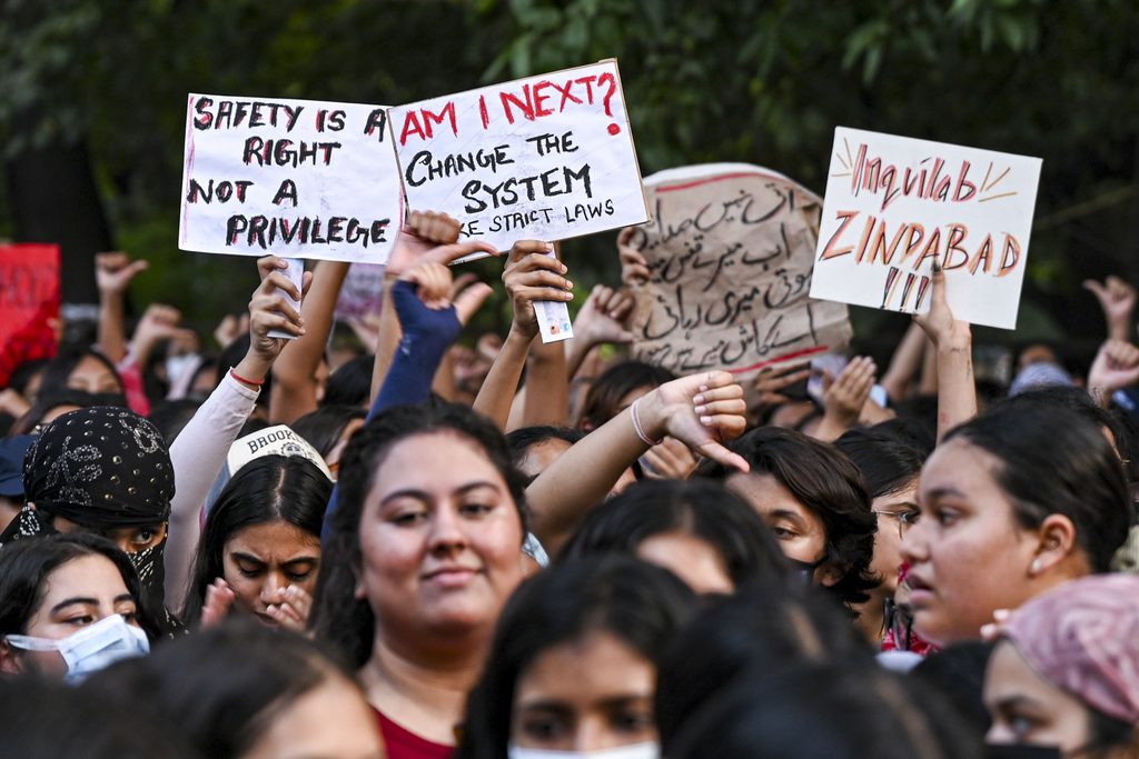 Protesters holding signs demanding safety and justice during a rally at LSR College.
