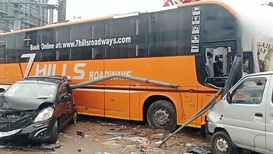 Bus crashes into hotel, causing damage to nearby vehicles and street debris in Shamshabad.