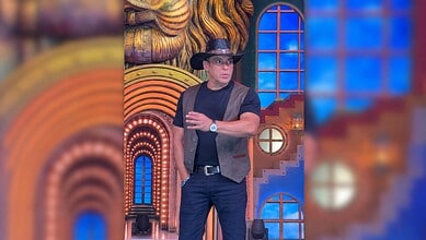 Salman Khan on Bigg Boss 20 set wearing a hat and casual attire, looking surprised.