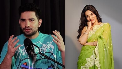 Comedian Samay Raina speaking at an event with a woman in a green saree smiling nearby.